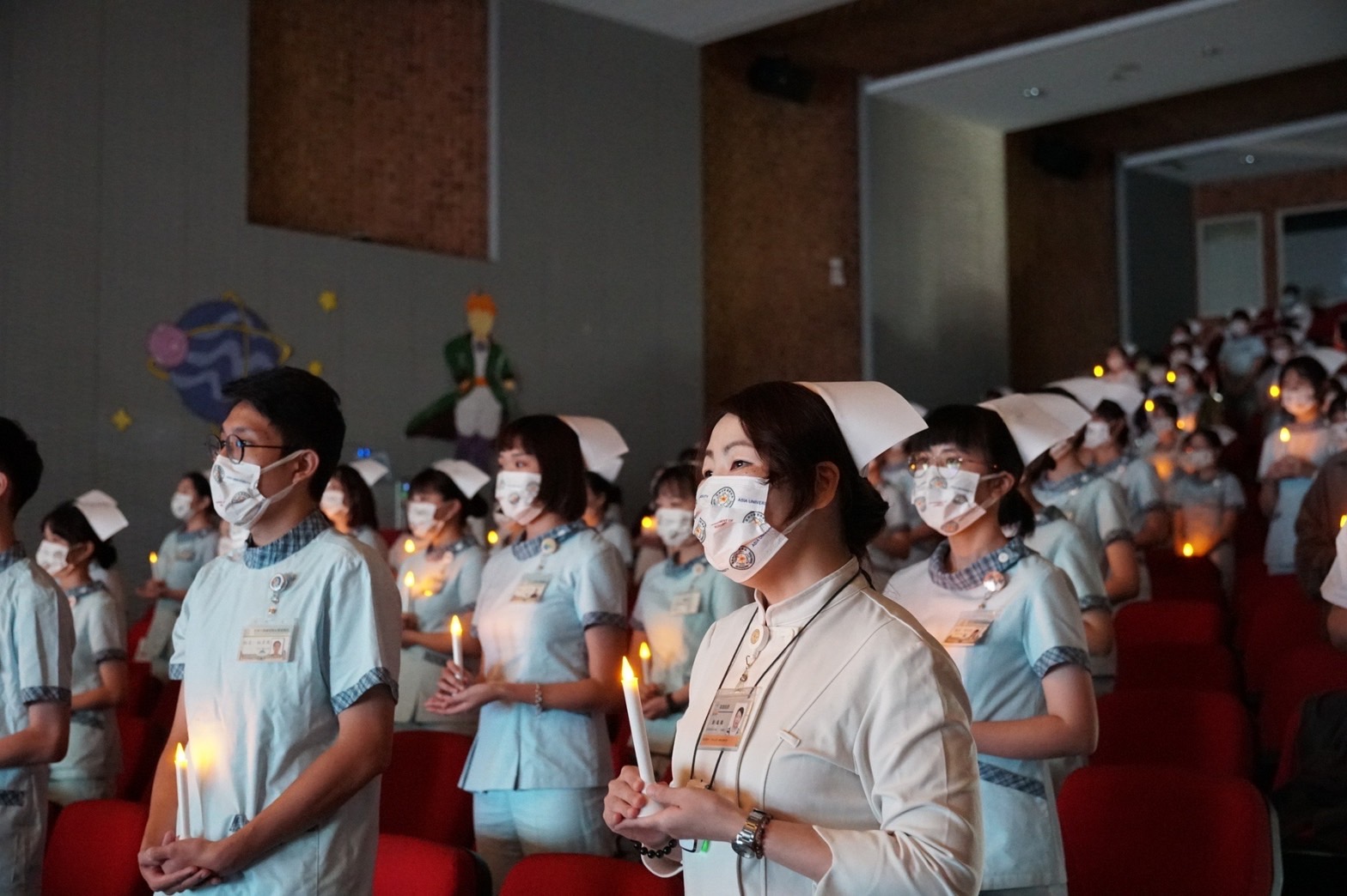 圖為在加冠傳光典禮上，由師長傳光給受冠生，象徵護理專業使命的傳承。